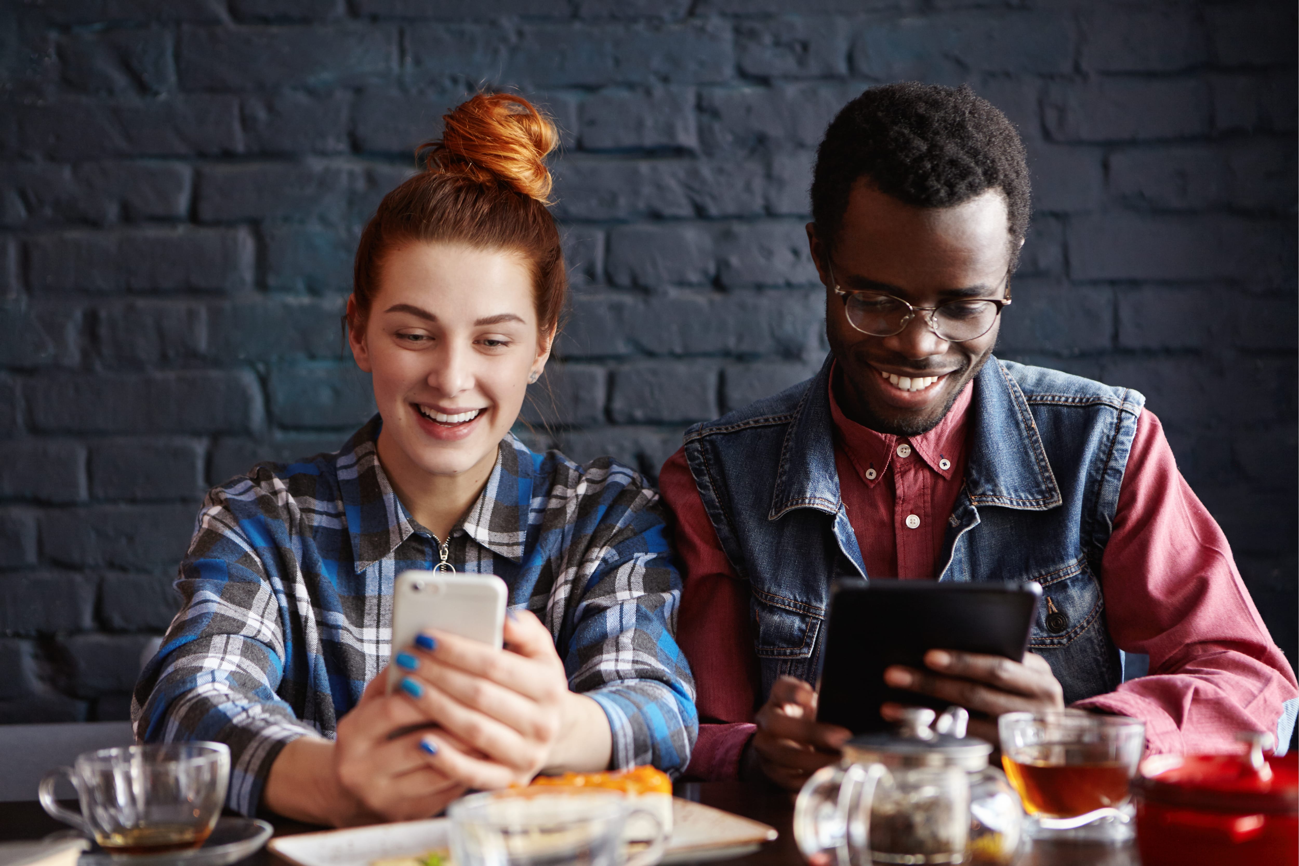 two students on their phone reading poll results