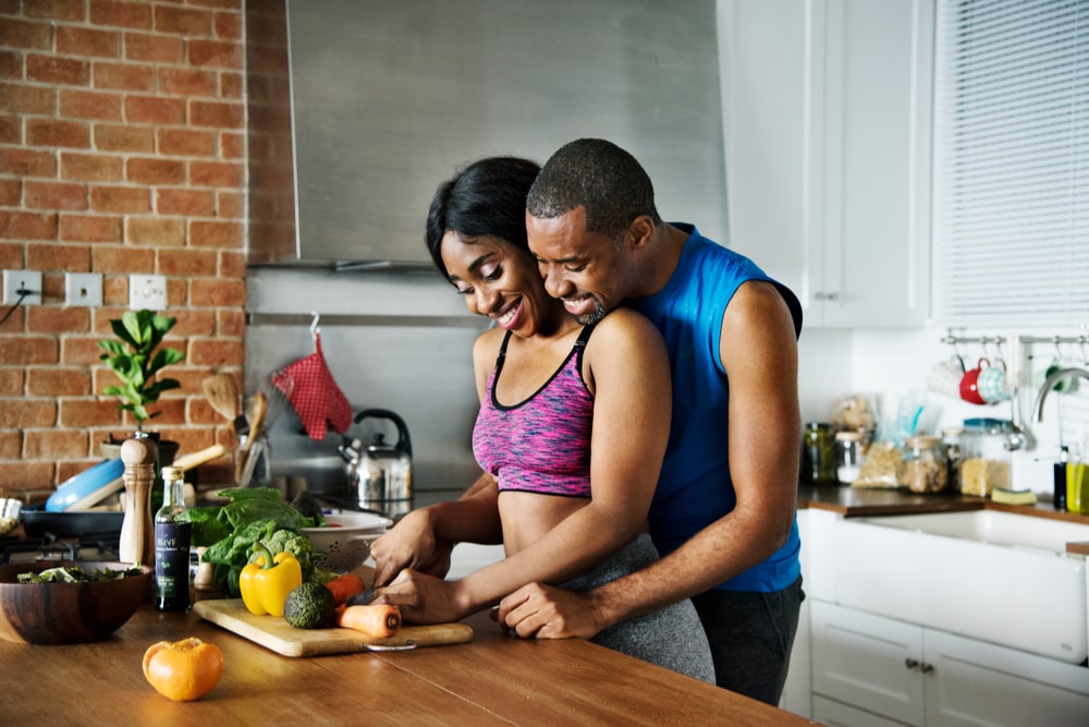 Couple cooking healthy foods together